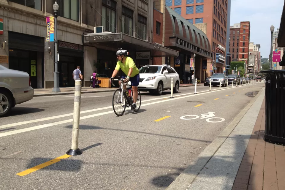 Cyclist riding on a downtown Pittsburgh bike lane